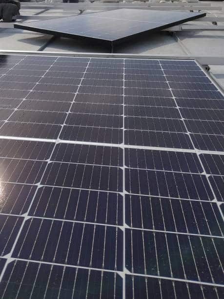 Closeup of photovoltaic panels on a rooftop. Installing photovoltaic modules on a rooftop.